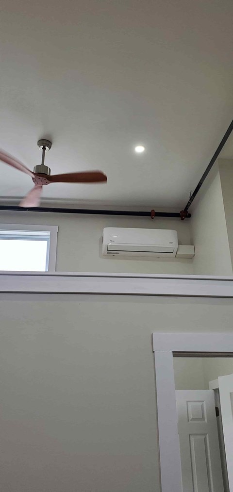 A ceiling fan is mounted on a white ceiling.