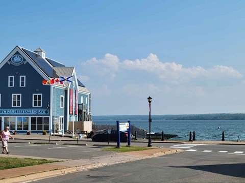 A blue building with the words "Director Heritage Quay" on it.