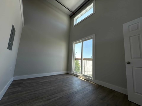 A room with a window and a door.