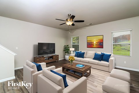 A living room with a television, couch, and coffee table.