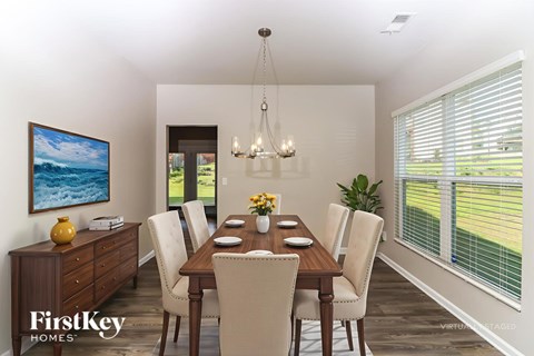 A dining room with a wooden table and chairs.