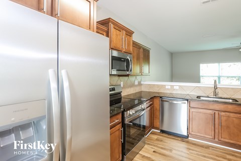 A kitchen with wooden cabinets and stainless steel appliances.