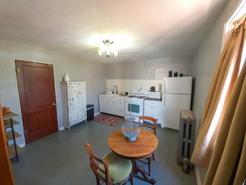 A kitchen with a table and chairs in the middle of the room.