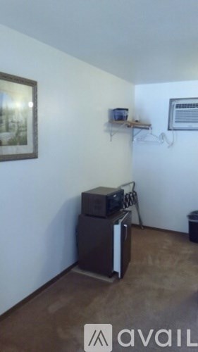 A room with a television and a picture on the wall.