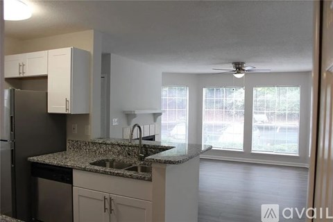 A kitchen with granite countertops and stainless steel appliances.