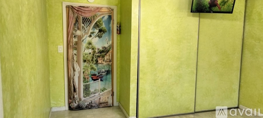 A door with a painting of a tree and a fence.
