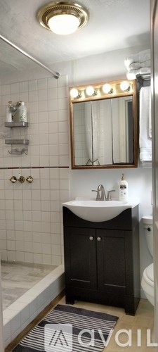 A bathroom with a sink and a mirror.