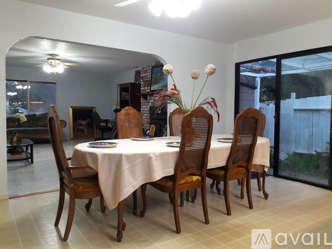 A dining room with a table set for six.
