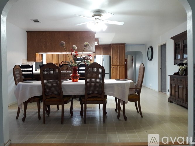 A dining room with a table set for six.