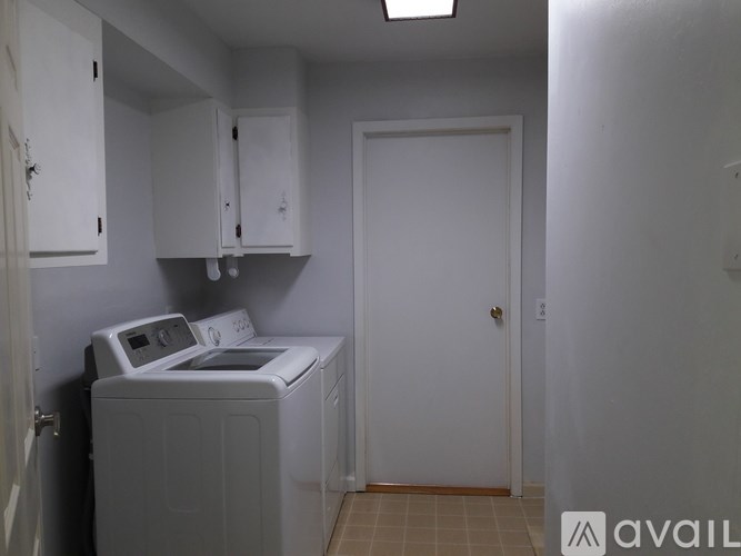 A small laundry room with a washer and dryer.