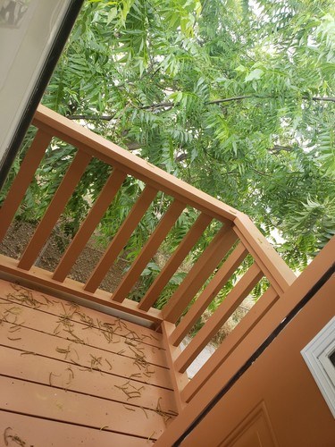 A wooden staircase with a railing is shown.