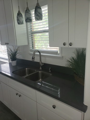 A kitchen with a sink and a window.