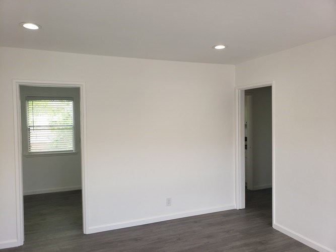 A room with a window and a door.