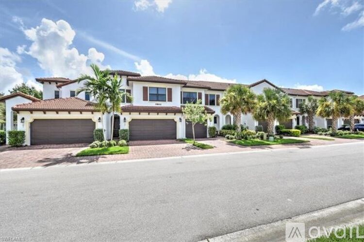 A row of houses with driveways in front of them.