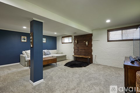 A living room with a white couch and a fireplace.