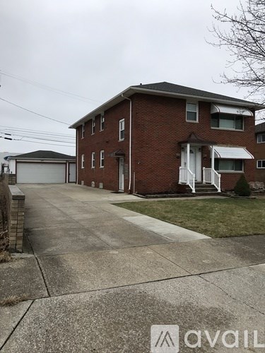 A two-story brick house with a white porch.