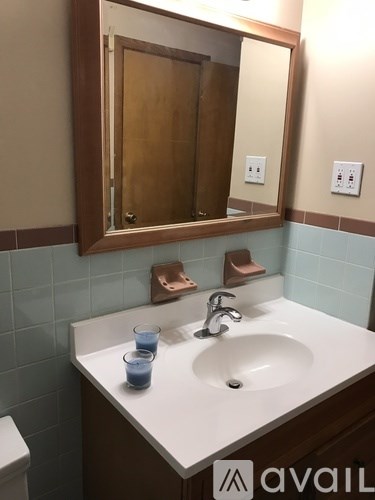 A bathroom with a sink, mirror, and toilet.