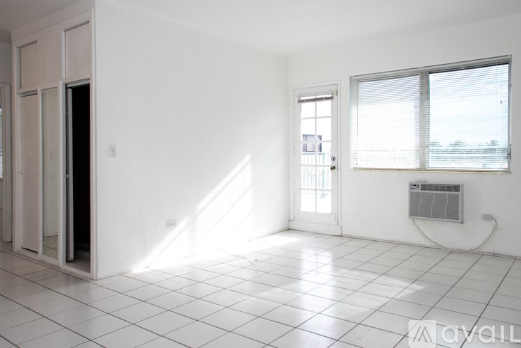 A room with white walls, a tiled floor, and a window with blinds.