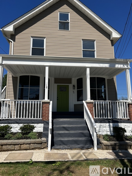 A house with a porch and a green door.