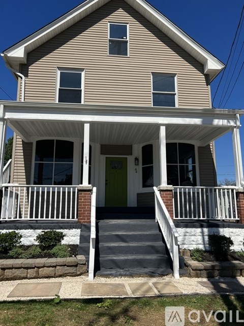 A house with a porch and a green door.