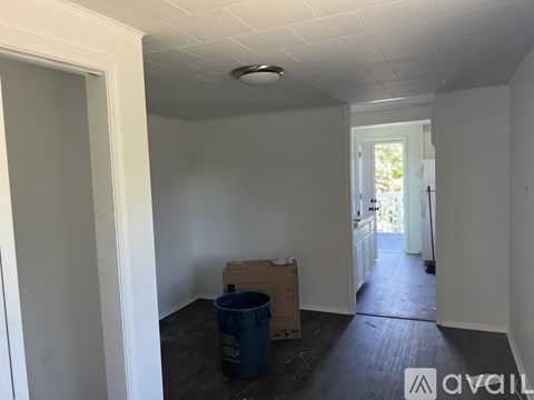 A room with a blue container on the floor.