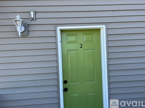 A green door with the number 2 on it.