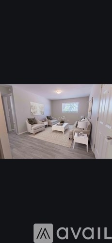 A living room with a couch, chairs, and a coffee table.