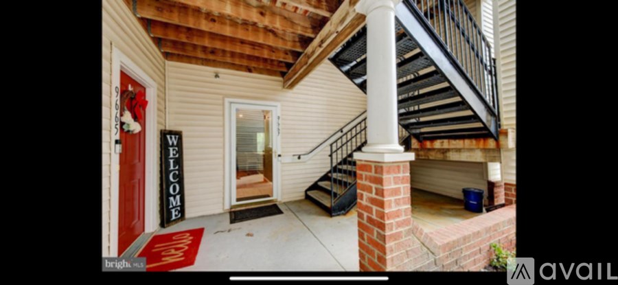A house with a red door and a sign that says "welcome".