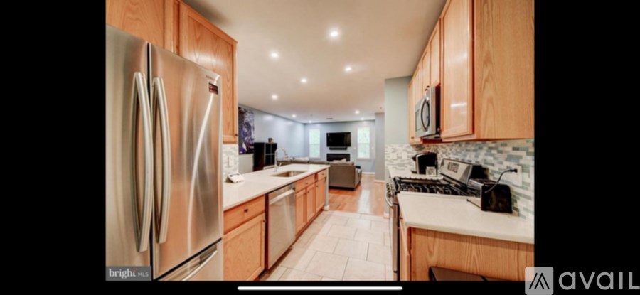 A modern kitchen with wooden cabinets and stainless steel appliances.
