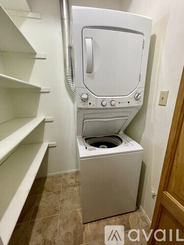A white oven with a stainless steel handle is installed in a kitchen.