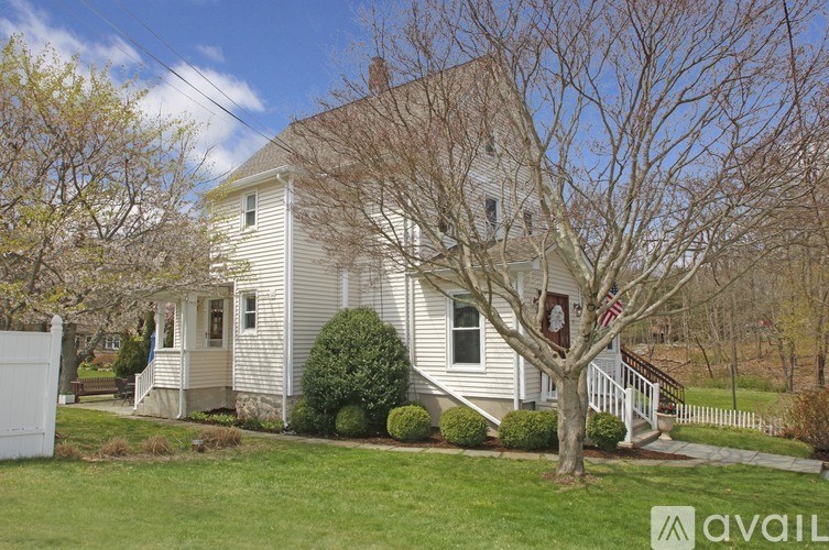 A house with a tree in front of it.