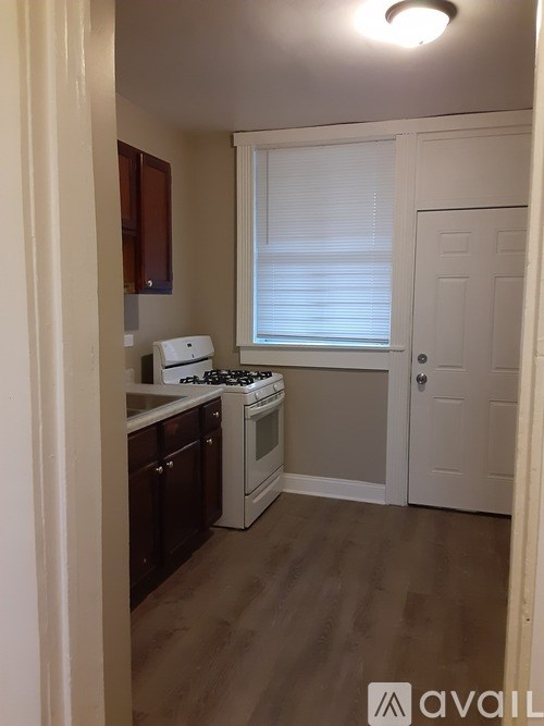 A kitchen with a stove, oven, and cabinets.