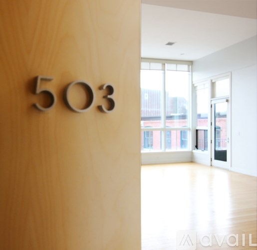 A room with a wooden door and a number 503 on it.