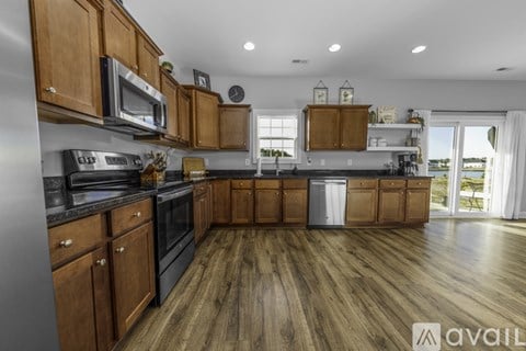A kitchen with wooden cabinets and a large island.
