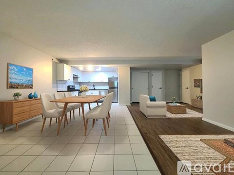 A modern kitchen with a dining table and chairs.