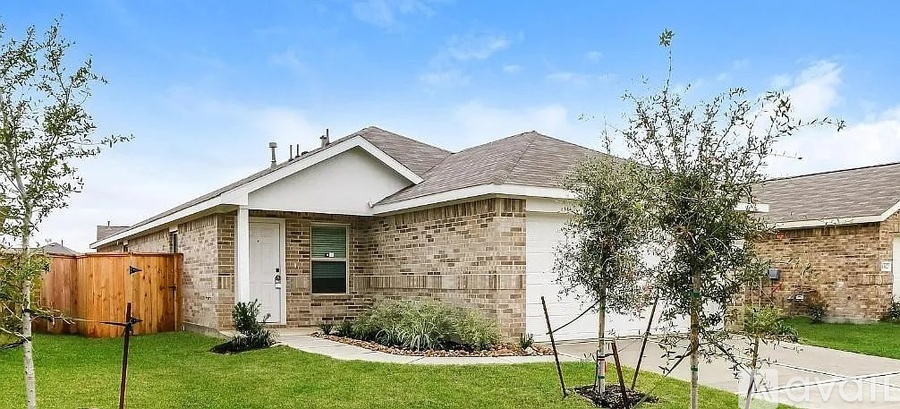 A house with a brown fence and a white door.