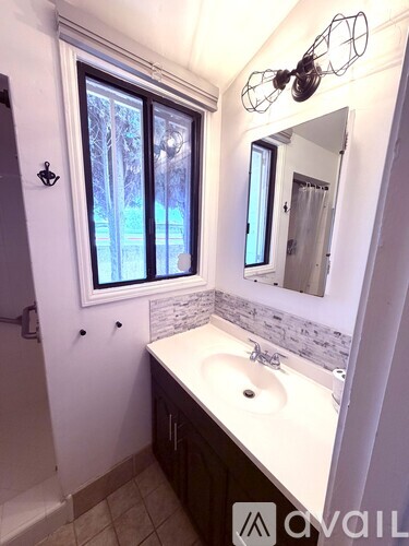 A kitchen with a black stove top oven and a black refrigerator.