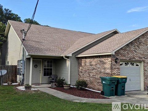 A house with a grey roof and a grey garage door.