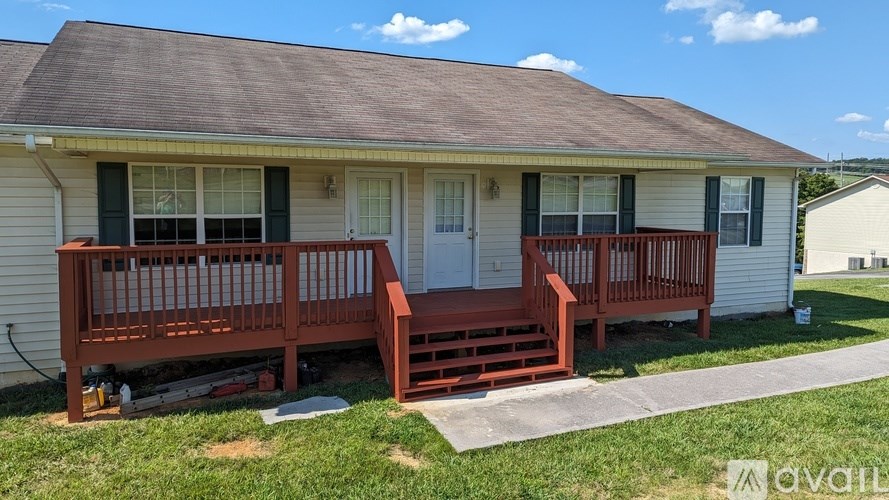 A house with a brown roof and a red deck.