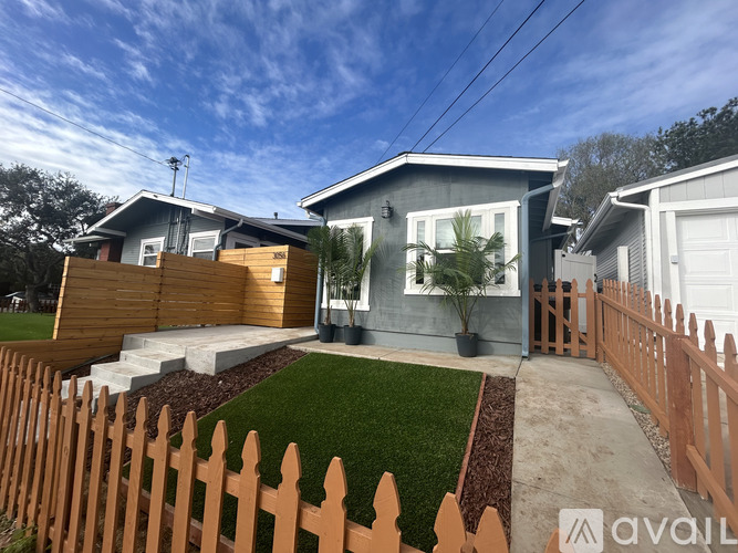 A house with a wooden fence in front of it.