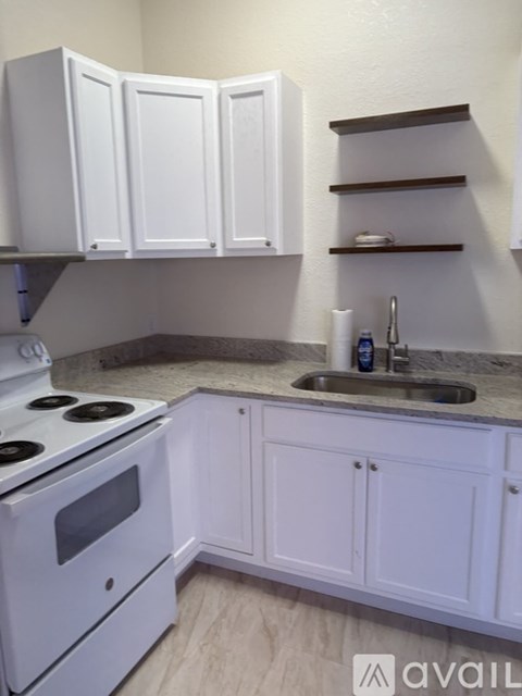 A kitchen with white appliances and cabinets.