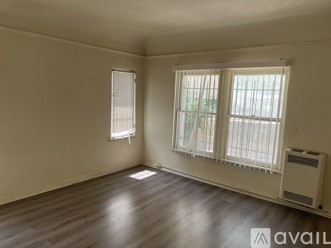 A room with a window and a wall-mounted air conditioner.