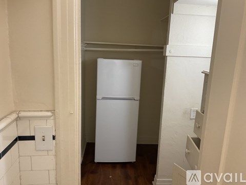 A white refrigerator in a small kitchen.