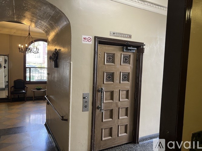 A brown door with a sign on the wall above it.