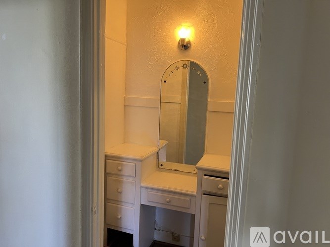 A bathroom with a sink, mirror, and light switch.