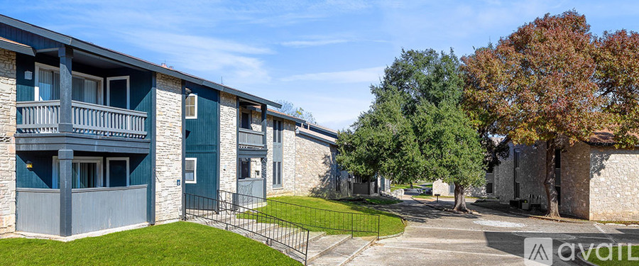 Apartment complex with a green lawn in front.