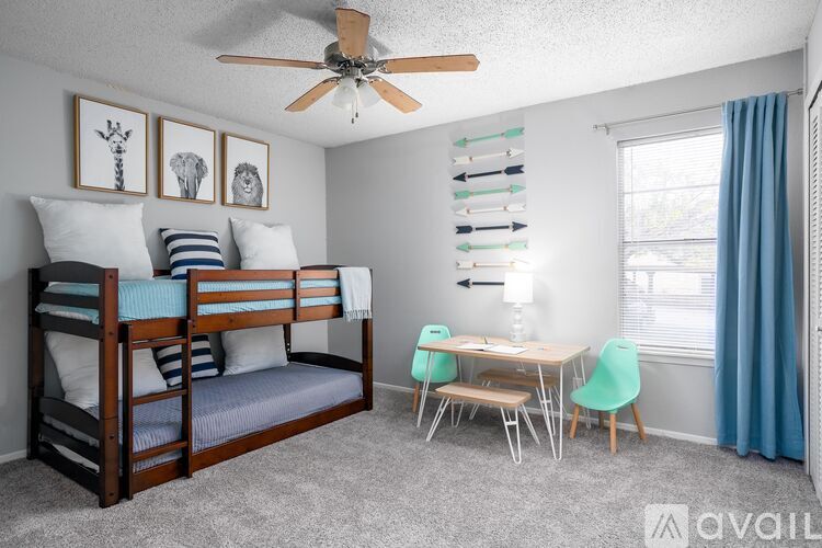 A bedroom with a bunk bed and a desk.