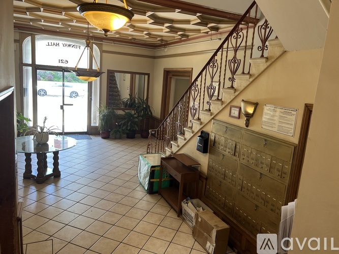 A large room with a staircase and a sign that says "HIAWK".