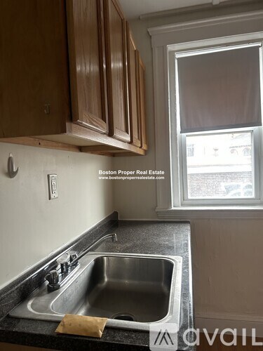 A kitchen with a sink and a window.