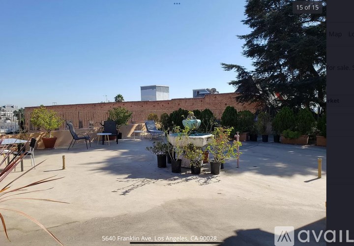 A parking lot with a building in the background and a sign that says "available".